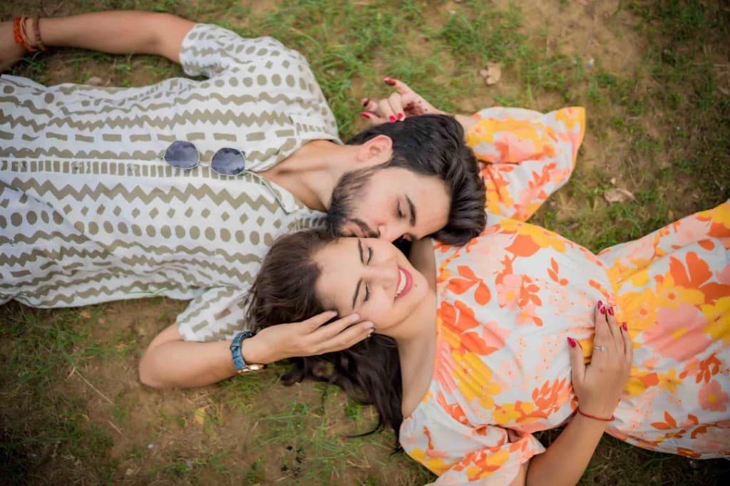 Candid couple lying on grass
